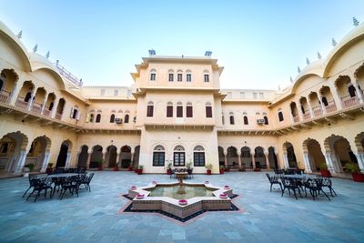 Empty chairs and tables in courtyard at alsisar mahal