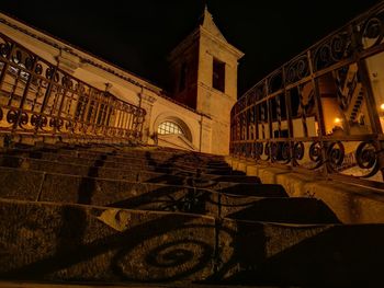 Illuminated building against sky at night