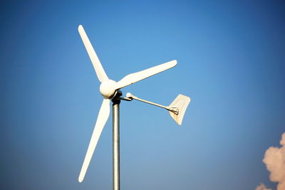 Low angle view of wind turbine against sky