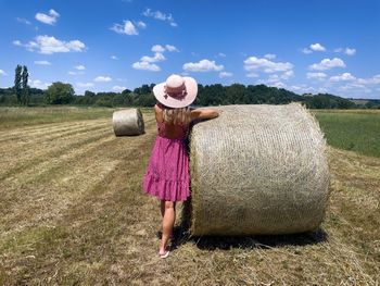 Hay bales on field against sky