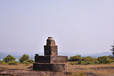 Castle on field against clear sky