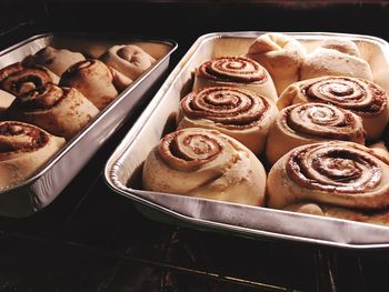 High angle view of cinnamon buns in trays 