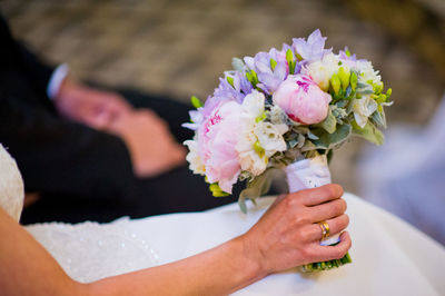 Close-up of woman holding bouquet of rose