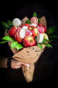 Close-up of hand holding fruits