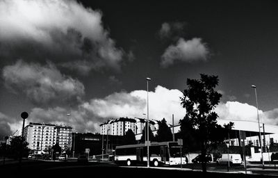 Cars on street in city against sky