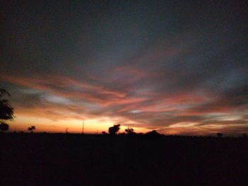 Silhouette of landscape against dramatic sky