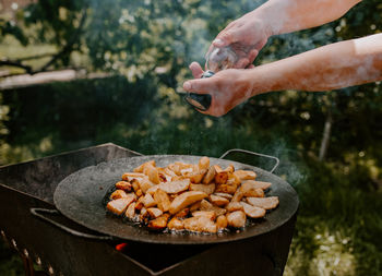 Cropped hand of man preparing food