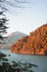 Scenic view of sea and mountains against clear sky