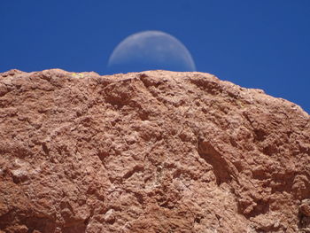 Close-up of rock against blue sky