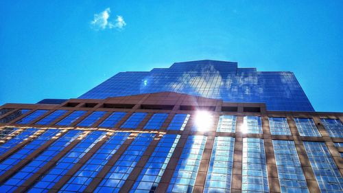 Low angle view of modern building against blue sky