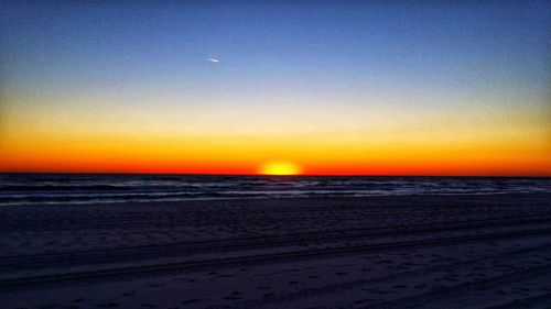 Scenic view of sea against clear sky during sunset