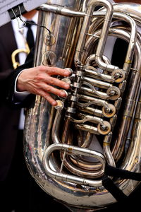 Midsection of man playing tuba