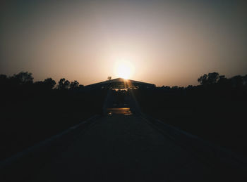 Silhouette trees against sky during sunset