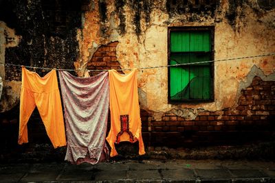 Clothes drying against brick wall