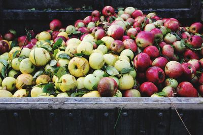 Close-up of apples in crate at market stall