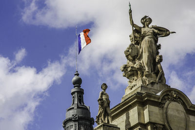 Low angle view of statue against cloudy sky