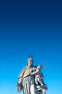 Low angle view of statue against clear blue sky