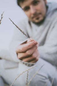 Midsection of man holding straw