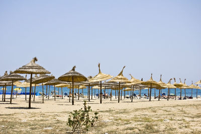 Gazebo on beach against clear sky