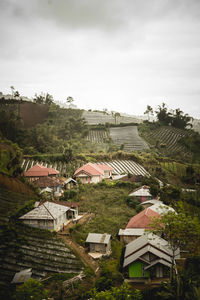 High angle view of houses and trees against sky