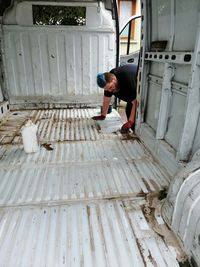 High angle view of man sitting outdoors