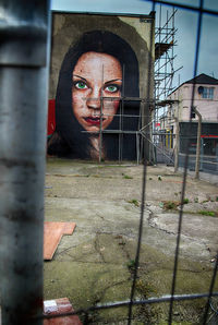 Portrait of man standing by window of abandoned building