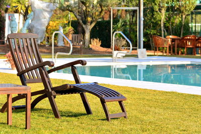 Empty chairs and tables in swimming pool