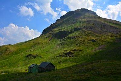 Scenic view of green mountain against sky