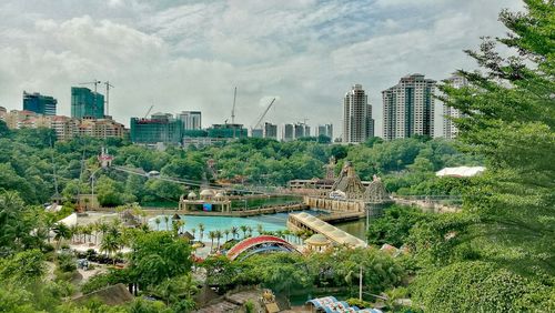 View of cityscape against cloudy sky