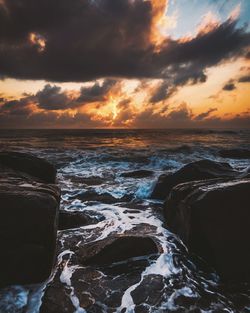 Scenic view of sea against dramatic sky