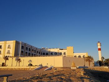 Buildings against clear blue sky