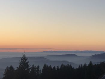 Scenic view of silhouette mountains against sky at sunset