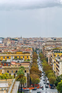 Aerial view of buildings in city against sky