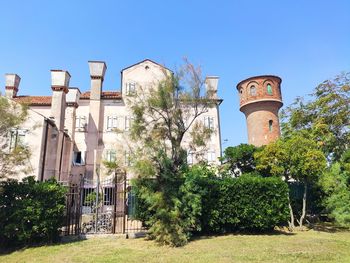 Low angle view of old building against clear blue sky