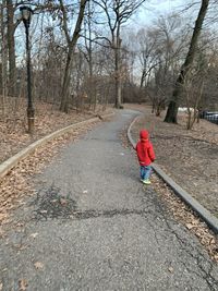 Full length of child standing on road during winter