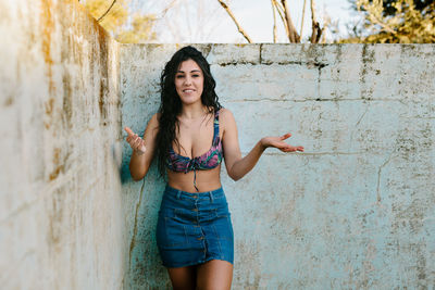 Portrait of beautiful woman standing at abandoned swimming pool