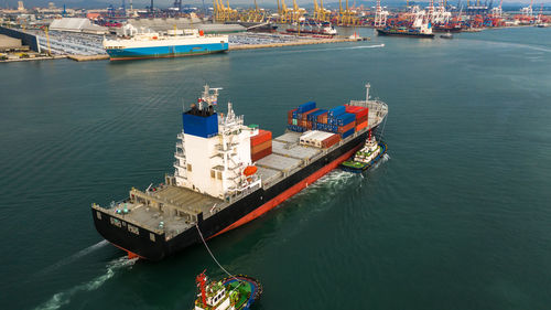 Container ship carrying container box in import export to commercial port, global business cargo.