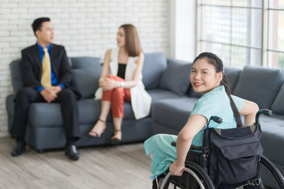 Portrait of young couple sitting in corridor