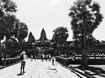 People at temple against sky