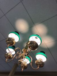 Low angle view of illuminated pendant light hanging on ceiling
