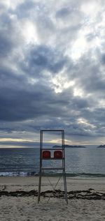 Lifeguard hut on beach against sky