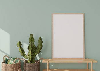 Empty vertical picture frame on light green wall in modern living room. mock up interior