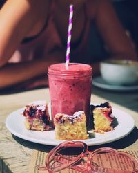 Close-up of drink and dessert in plate on table