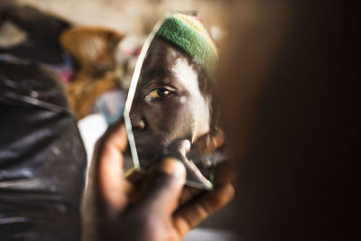 Close-up portrait of young man smoking cigarette