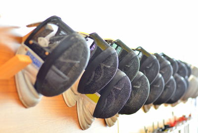 Close-up of shoes hanging on metal