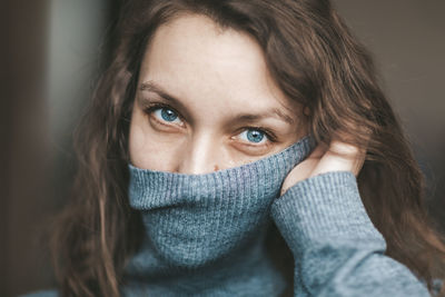 Close-up portrait of woman covering face