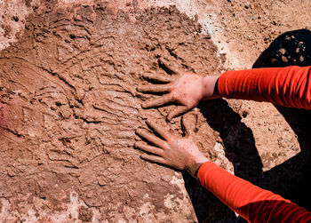 High angle view of human hand in mud