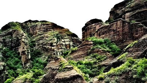 Low angle view of rocky mountain against sky