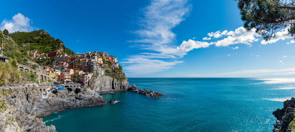 Panorama of manarola in cinque terre, italy, with the mediterranean sea on a sunny summer day