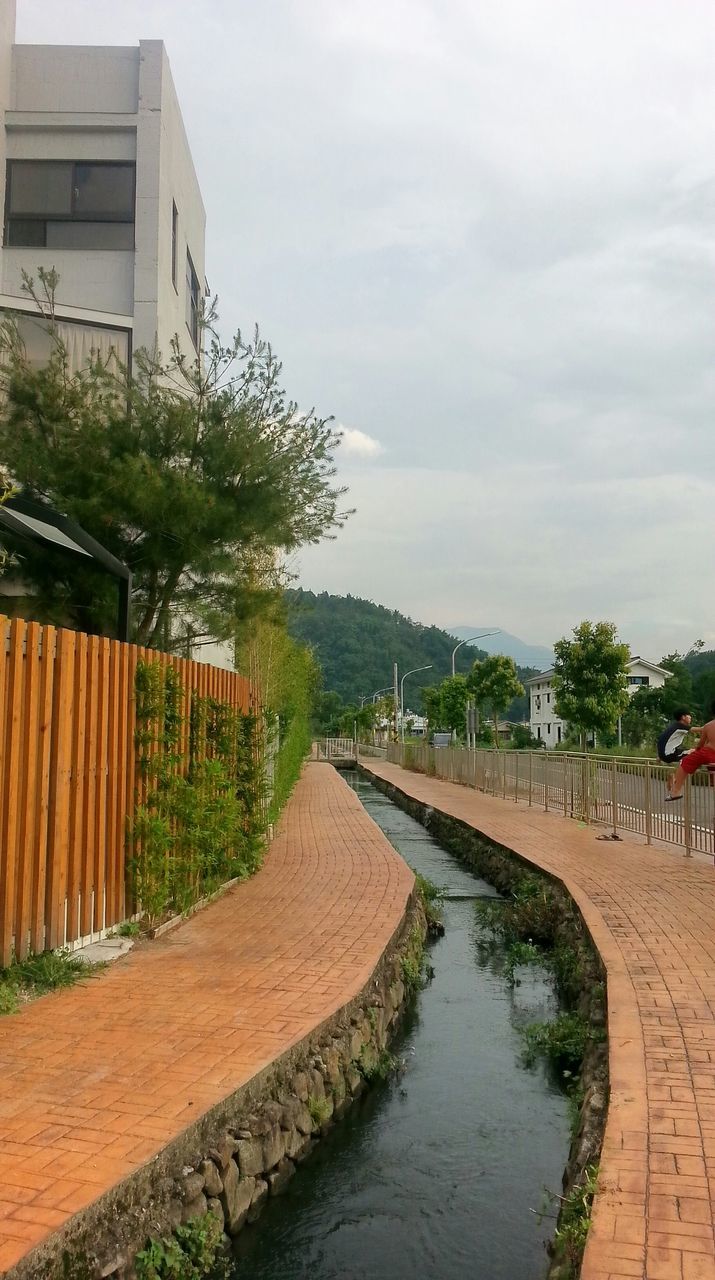 the way forward, sky, tree, diminishing perspective, building exterior, built structure, architecture, vanishing point, footpath, walkway, cloud - sky, water, pathway, cobblestone, tranquility, nature, tranquil scene, growth, outdoors, day